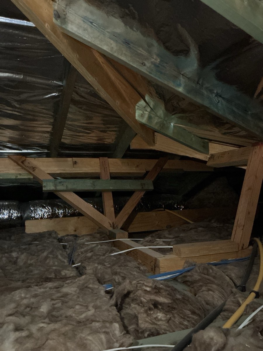 Insulation packed against a downlight